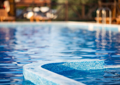 A close-up of the side of a blue swimming pool.